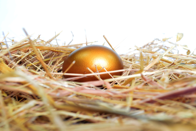 Golden egg on a bed of straw.