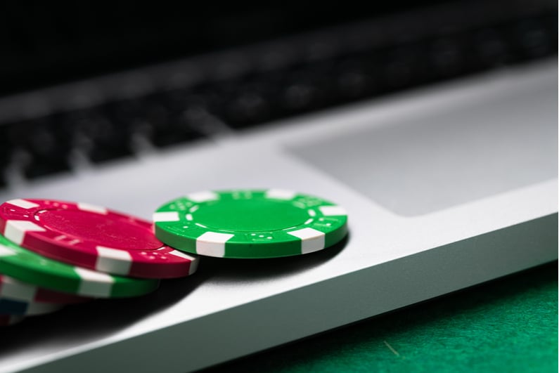 Closeup of laptop with poker chips